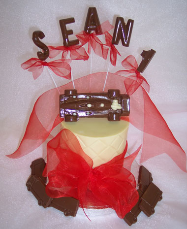chocolate race car theme on single chocolate tier, decorated with ribbon