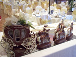 milk chocolate carriage and horses decorated with a gold rein
