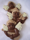 a picture of three chocolate musical cherubs